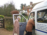 Two ladies boarding a minibus for a shopping trip